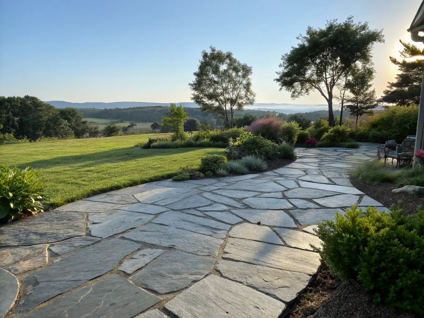 A spacious concrete patio with decorative stamped patterns and outdoor furniture, installed by Victoria Concrete Experts.
